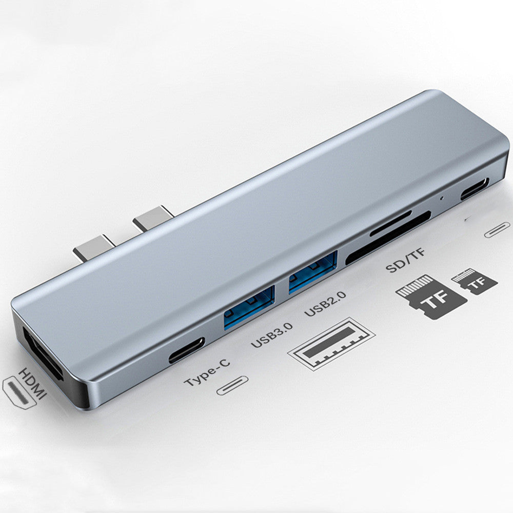 Silver aluminum laptop converter with 7-in-1 interface including HDMI, USB 3.0, USB 2.0, Type-C, SD/TF slots.